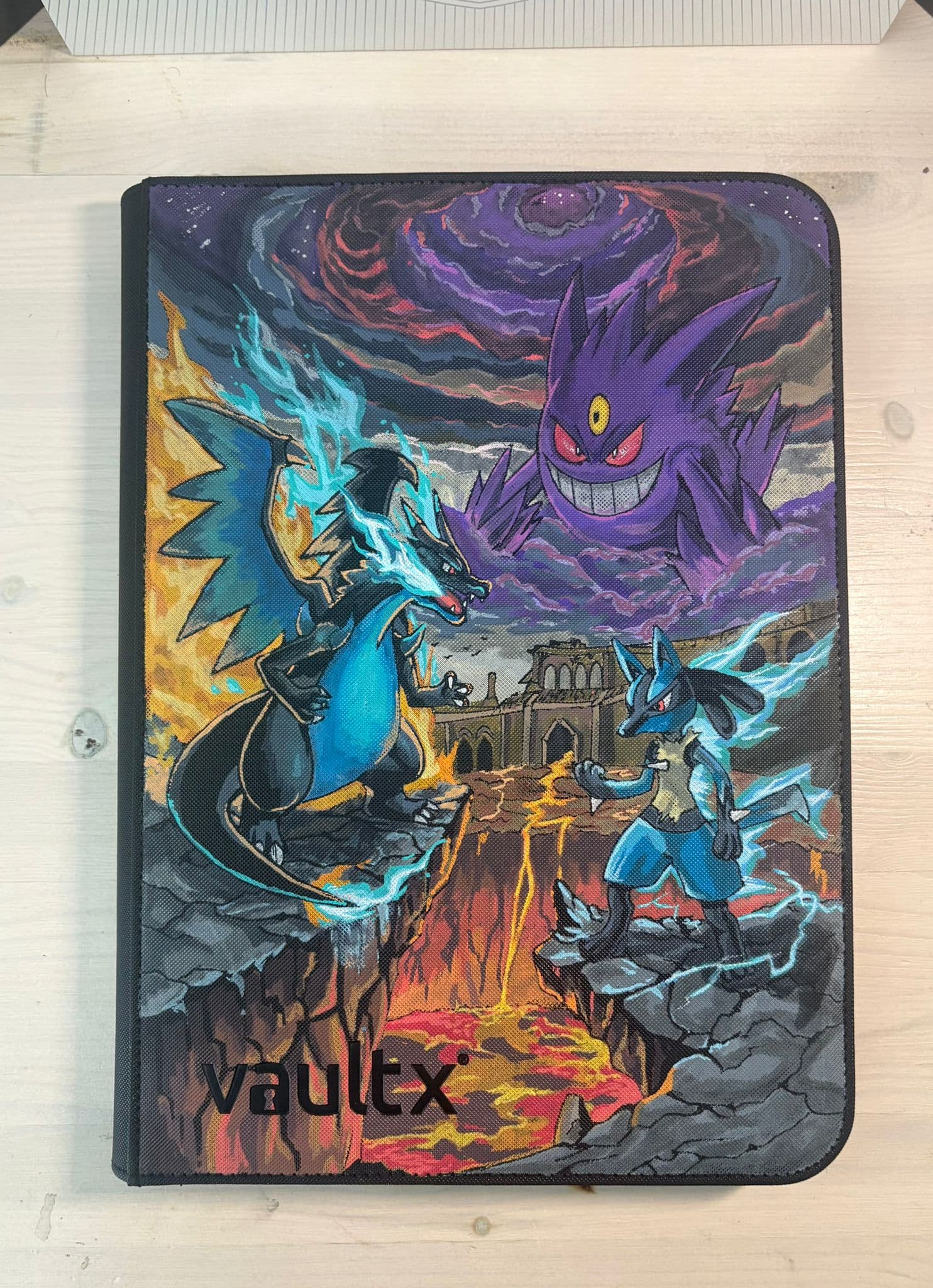 Custom binder with an epic battle between Charizard, Lucario and Gengar above a fiery landscape