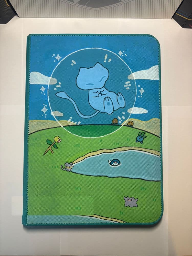 Custom binder with a sleeping Mew in a bubble above a dreamy pastel landscape