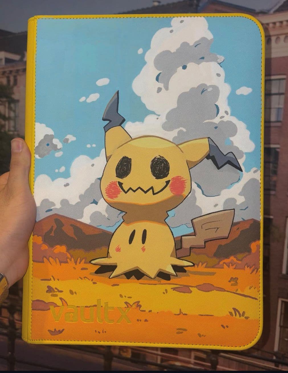 Custom Mimikyu binder against a dreamy cloudy sky
